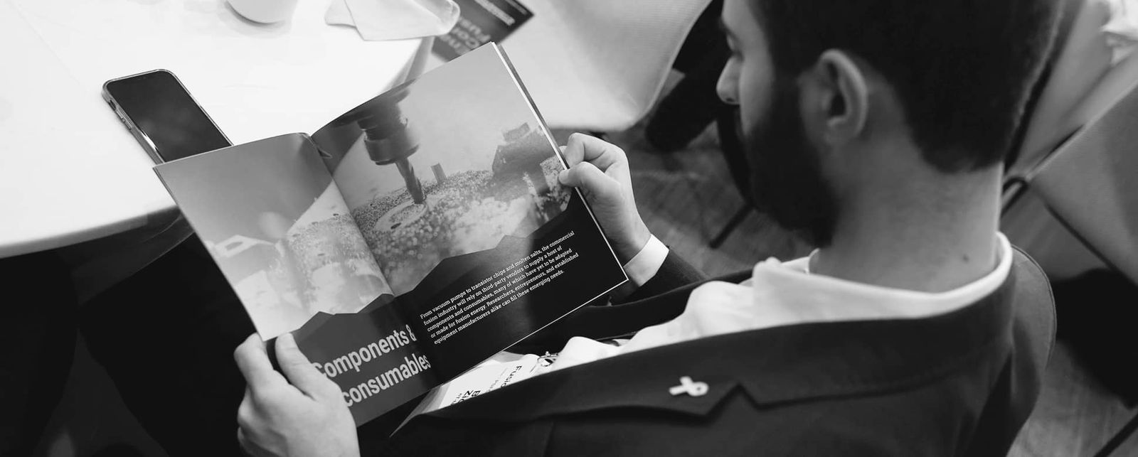 Photo of a man reading the Enabling Commercial Fusion report